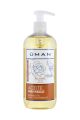 Botella de aceite para masaje relajante Uman 500 ml con etiqueta blanca y tonos suaves. 